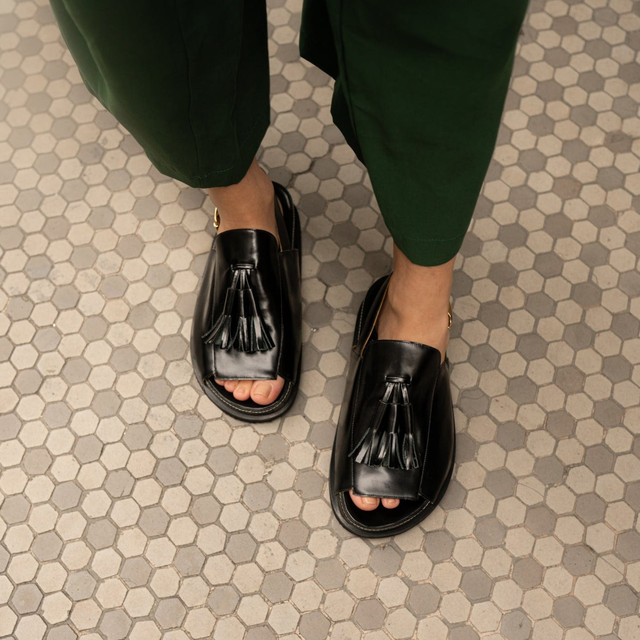 Rita Black Slingback Tassel  Sandals by Mafalda Handmade worn by model with green trousers