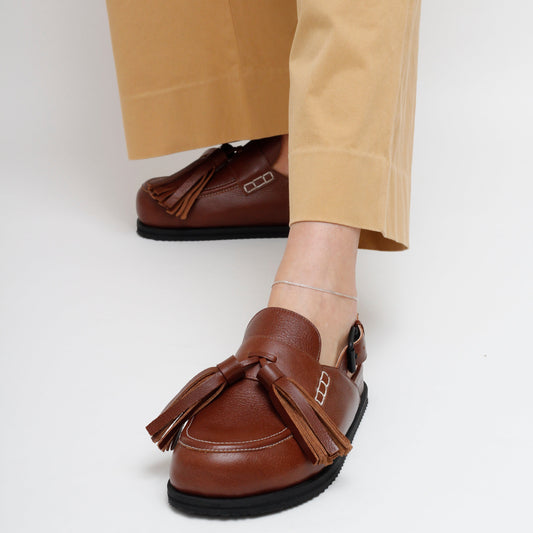 Zoe Brown Leather Tassel Mules by Mafalda Handmade worn by model with mustard trousers