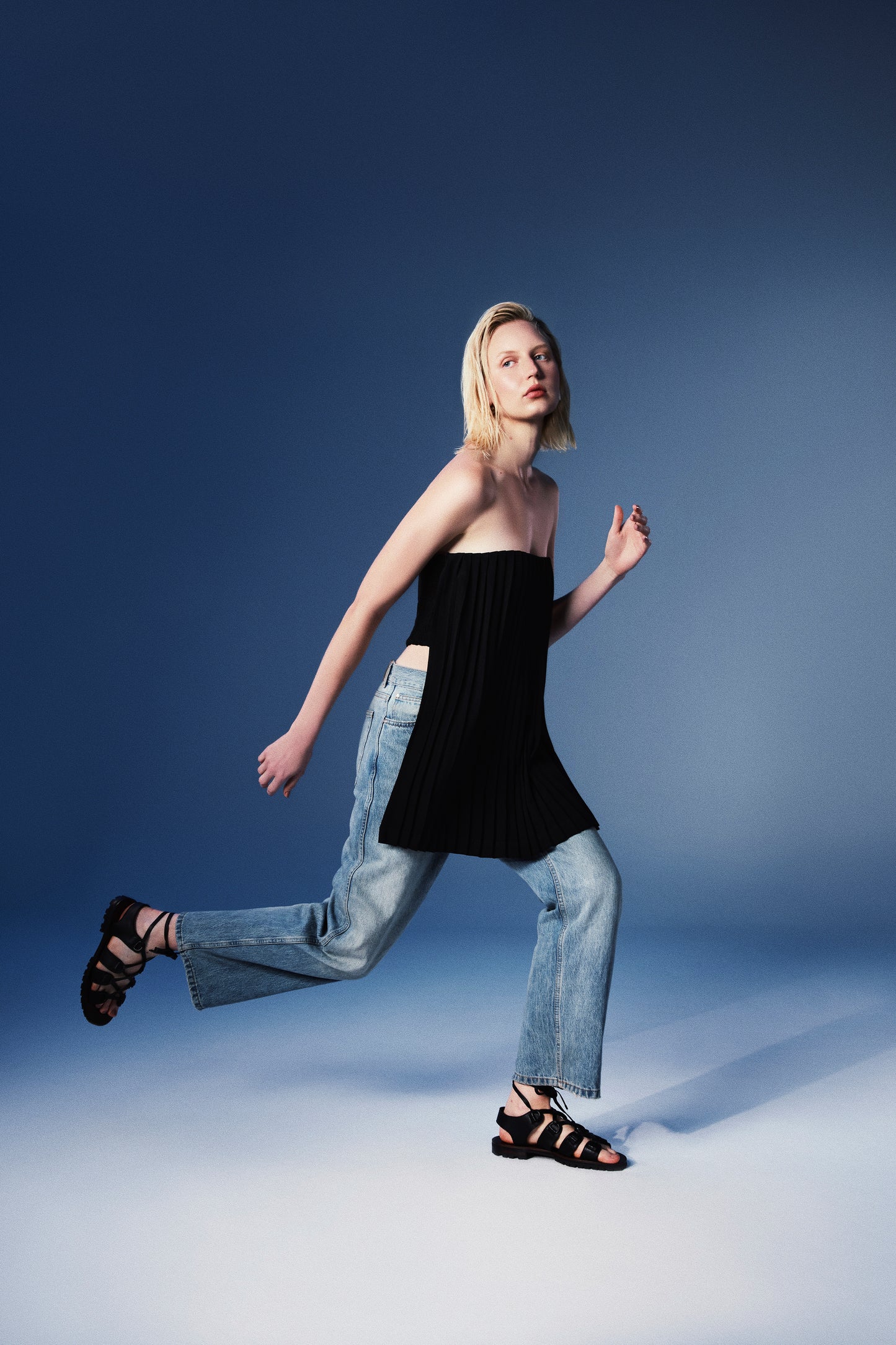 
Camelia Black Lace-up Sandals by Mafalda Handmade worn by model with jeans and black strapless top