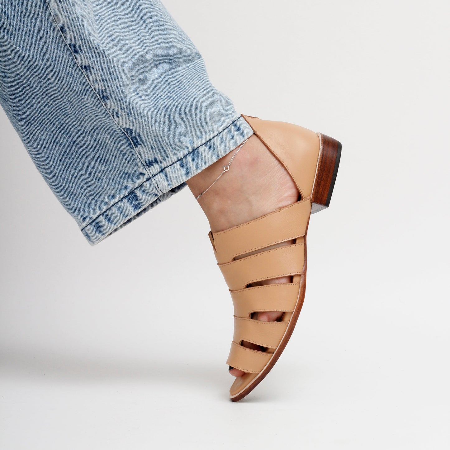 Tan flat leather sandal with cut-out design Gisele Peep-toe Smart Sandals by Mafalda Handmade on model with jeans