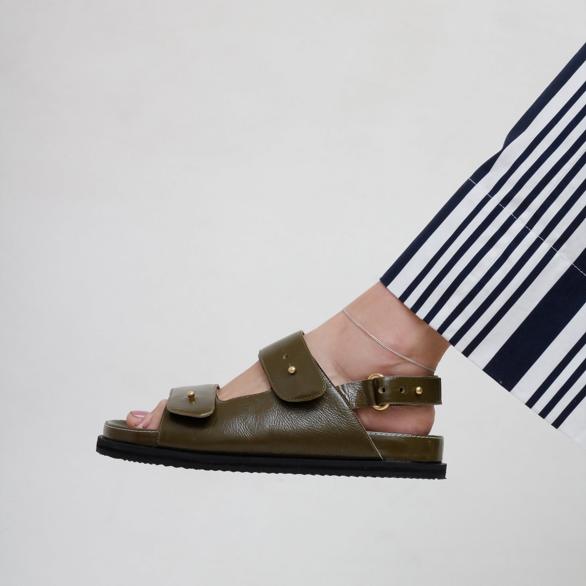 woman wearing stripped trousers and Margot Green Leather Chunky Sandals by Mafalda Handmade